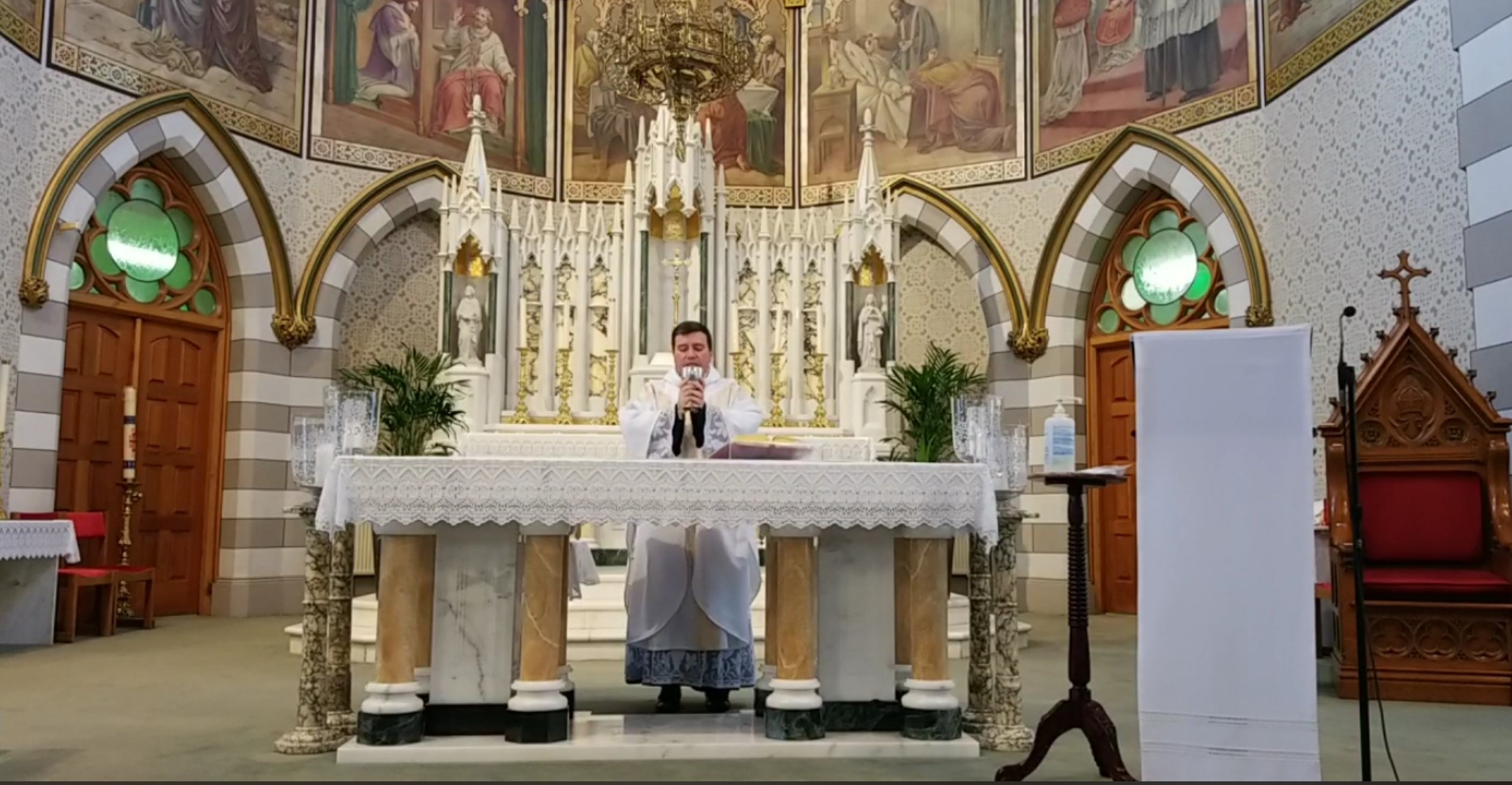 Father Willyans blessing the chalice at the altar
