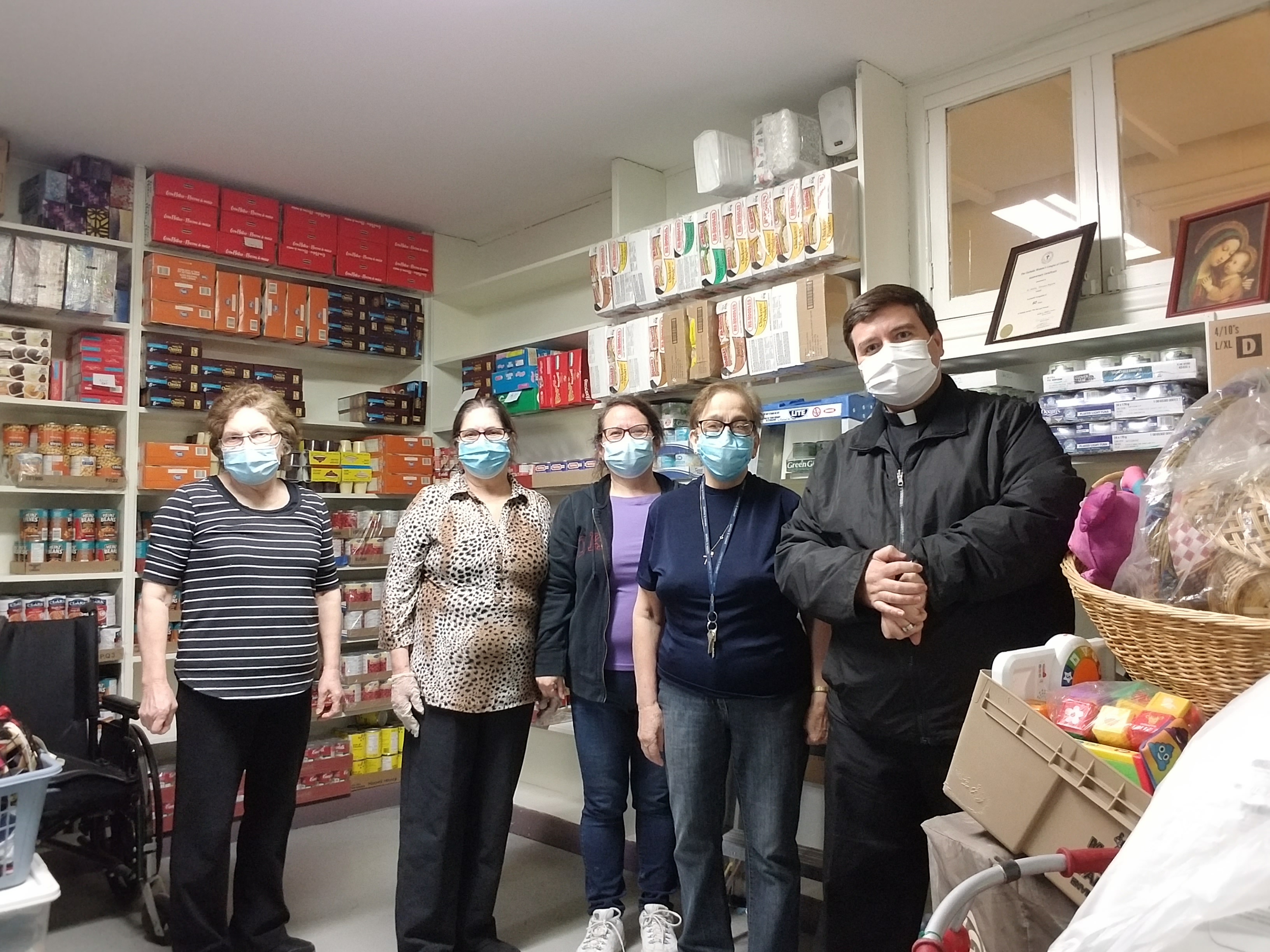 St. Vincent de Paul's Society Volunteers and Fr. Willyans at Food Bank