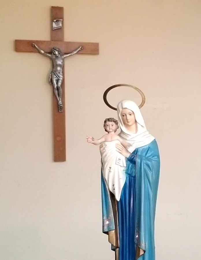 Statue of Our Lady Mother of the Church near a crucifix